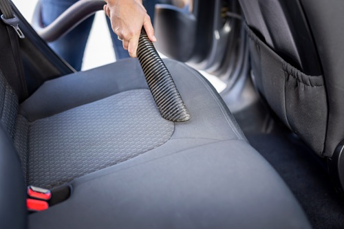 Vacuuming car seats during interior valet